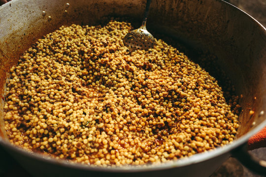 ORGOSOLO, SARDINIA /OCTOBER 2019: Cooking the traditional Fregula pasta in a big pan