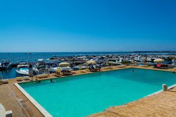 Fototapeta na wymiar View on San Felice Circeo sea bay with swimming pool and pier, Lazio, Italy