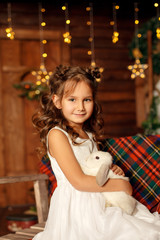 New Year 2020. Merry Christmas, happy holidays. Close-up portrait of a little girl Magic Light in Night Xmas Tree Interior