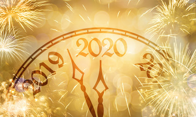 New Year clock near to the midnight of 2020, fireworks golden bokeh background