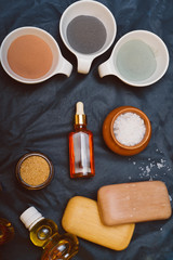 luxury Set of spa products with different kind of clay on black background. flat lay