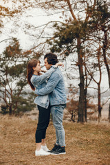 Fototapeta premium gentle and stylish couple are having a walk in the autumn park