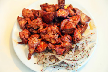Turkish liver kebab (Ciger Kebab) on the dinner plate