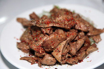 Turkish liver kebab (Ciger Kebab) on the dinner plate