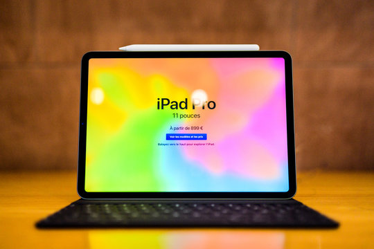 PARIS, FRANCE - NOV 7, 2018: Hero object of the new 11 inch Apple iPad Pro with Face ID, A12X Bionic with Neural Engine and thin completely redesigned body and price of 899 Euros