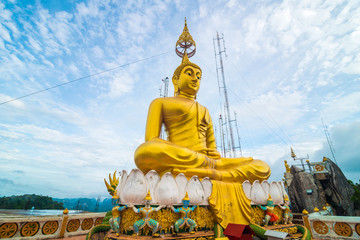 Golden buddha statue locate on peak of mountain