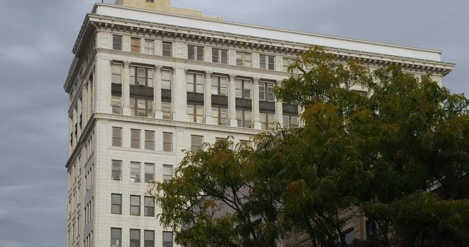 An establishing shot of the top floors of a building in downtown Charleston, West Virginia on an Autumn day.  	