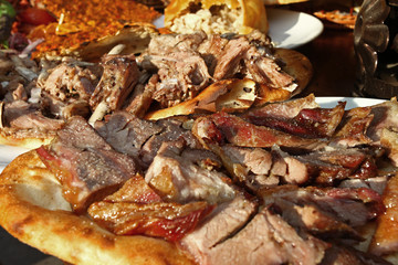 Traditional Turkish food 'Bread with meat' and 'Lahmacun' on the restaurant table.