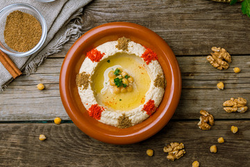Traditional homemade hummus on wooden table