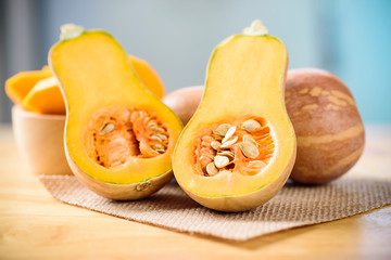 Half butternut squash on wooden background
