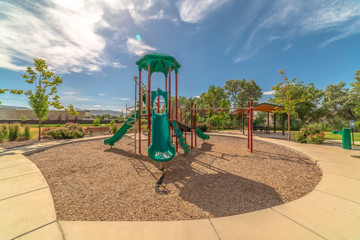 Slides with climbig bars at a playground under blue sky on a sunny day