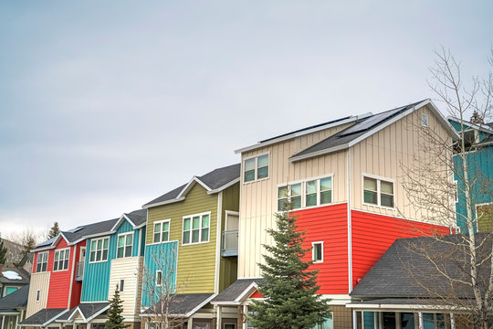 Townhouses with colorful exterior walls with cloudy sky background in winter