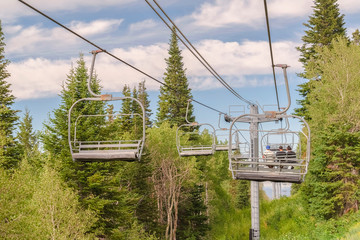 Chairlifts against trees and sky at a ski resort in Park City during off season