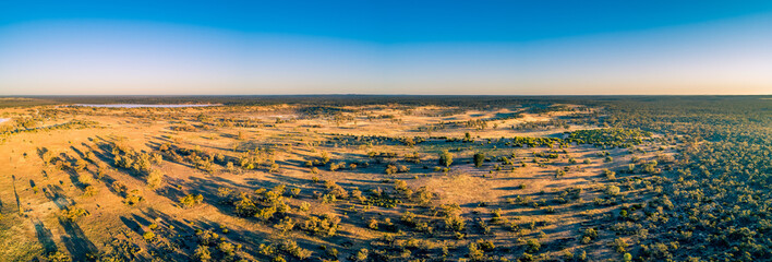 Wide aerial panorama of Australian outback at sunset