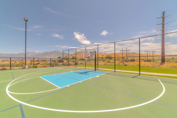 Outdoor green basketball court three point line