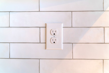 Power outlet on white wall in home