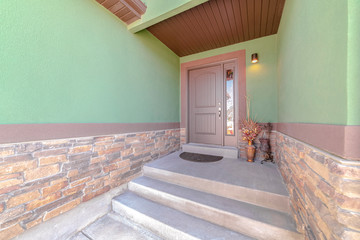 Front porch and door of traditional green home