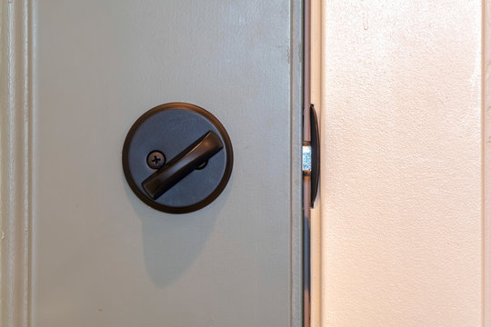 Close Up Of Locked Deadbolt Latch On Home Door