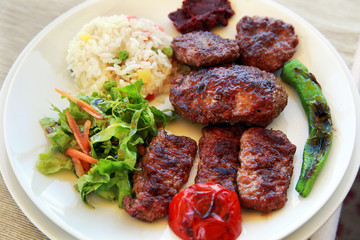 Meatballs with rice and vegetables on the dinner plate