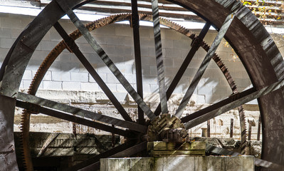 an old forgotten Mill Wheel rests out of the water after years of hard work