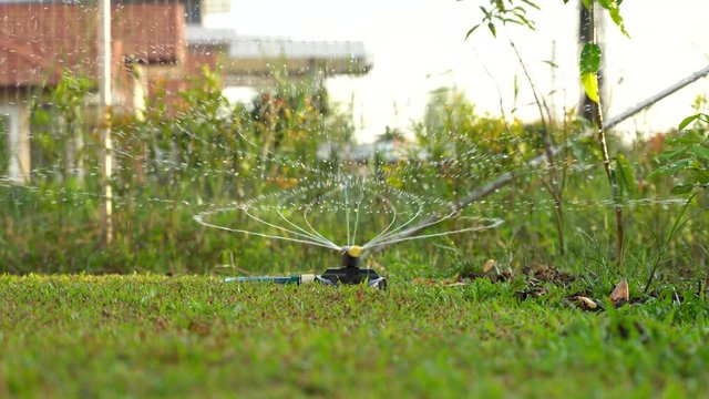 Modern rotating water sprinklers in glass lawns at home garden