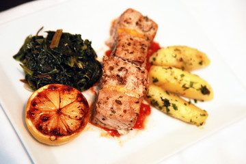 Grilled chicken with sauce and vegetables on the dinner plate