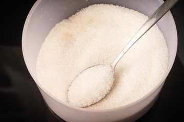 Closed up shot of Raw Sugar in a container. Unhealthy eating concept
