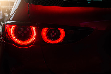 Close up car tail light red color on service blurry background.Using wallpaper background for automobile transport and automotive image.