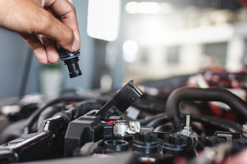 Man service mechanic maintenance inspection service maintenance car Check engine oil level car in garage showroom dealership blurred background.