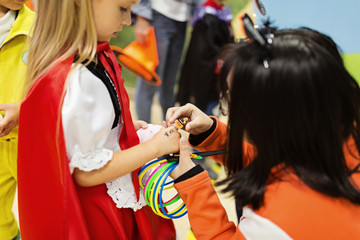 Obraz na płótnie Canvas Funny kids in carnival costumes indoors. Cheerful children play in kindergarten