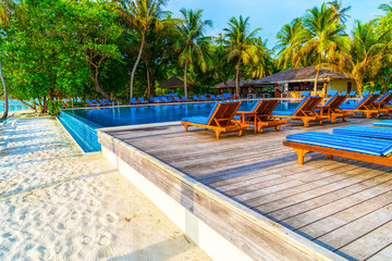 Lounge chairs on a beautiful tropical beach at Maldives
