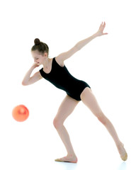 Girl gymnast performs exercises with the ball.