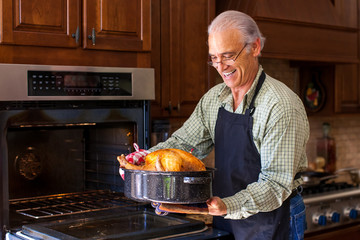 Good looking senior man holding turkey