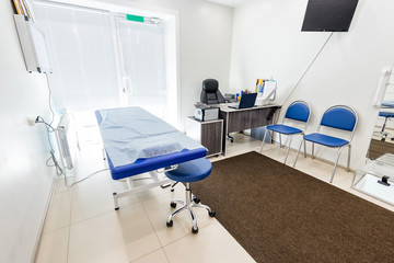 Medical office, couch with an ultrasound machine, table and computer