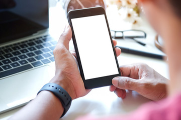 Mock up smartphone of man hands holding smart phone with blank copy space screen for your text message or information content, female reading text message on cell telephone during in urban setting.