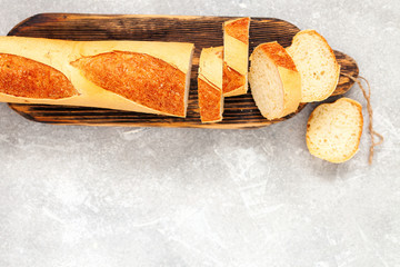 Sliced bread over gray stone table. Top view from above with copy space.