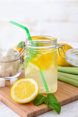 Jar of tasty lemonade on table