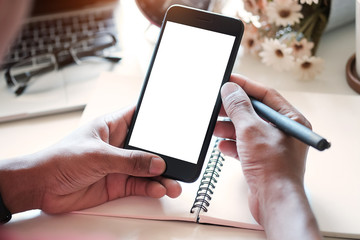Mock up smartphone of man hands holding smart phone with blank copy space screen for your text message or information content, female reading text message on cell telephone during in urban setting.