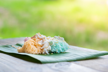 Thai Desserts (Ka-Nhom-Ray-Rai or Rang-rai ), Rice flour dumpling topped coconut milk and sugar mixed with sesame, colorful Thai desserts, Thailand traditional food.