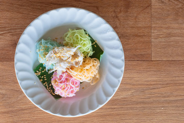 Thai Desserts (Ka-Nhom-Ray-Rai or Rang-rai ), Rice flour dumpling topped coconut milk and sugar mixed with sesame, colorful Thai desserts, Thailand traditional food.
