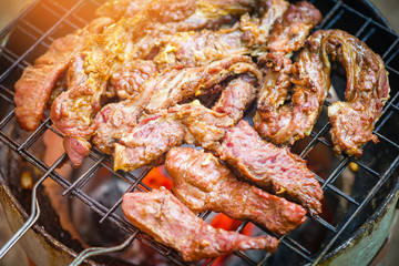 Roast beef sliced meat steaks on the grill with flames - Grilled beef barbecue at street food Thailand Asian