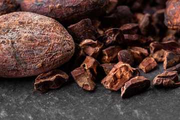 Dark chocolate pieces crushed and cocoa beans, top view