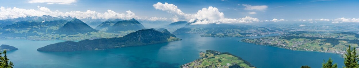 Obraz premium Switzerland, Panoramic view on green Alps in clouds and lake Lucerne