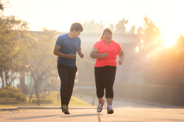 Asian fat girl run with her trainer in a garden