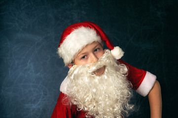 Portrait of a boy in the image of Santa Claus . Merry Christmas