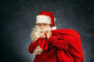 Portrait of a boy in the image of Santa Claus . Merry Christmas