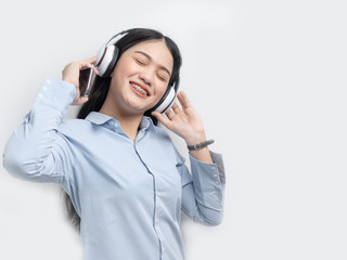 Happy Asian woma using smart phone and headphone listening music, lifestyle concept.