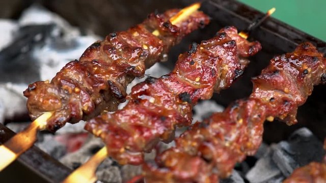 Sizzling grilled beef skewer at a street market in Tokyo.