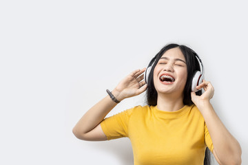 Naklejka premium Happy Asian woman using headphone on white background, lifetyle concept.
