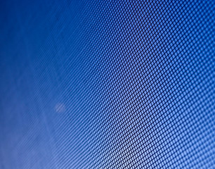 Fly screen mesh against blue sky
